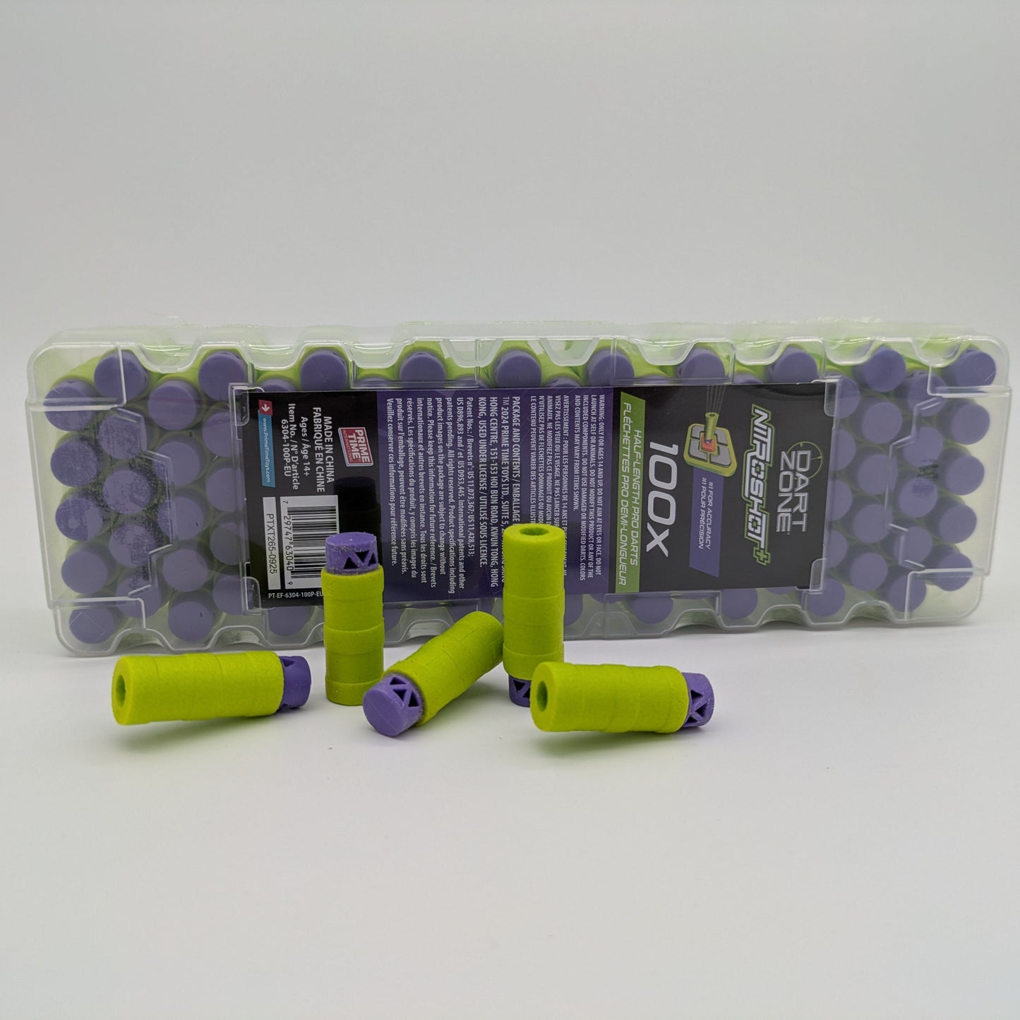 Green and purple darts with a clear plastic packaging on a white background