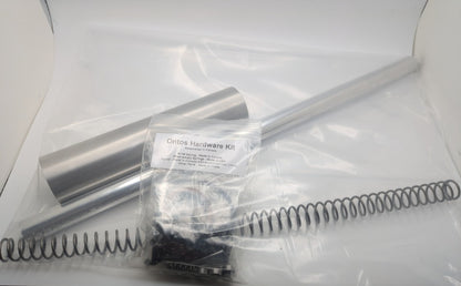 Ontos hardware kit with spring, Metal Plunger, Barrel, and packaging on a white background